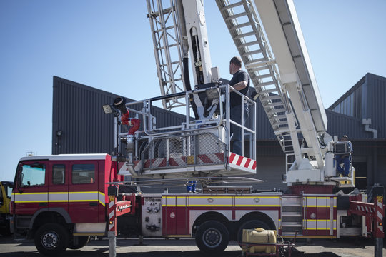 Mechanics maintaining fire engine