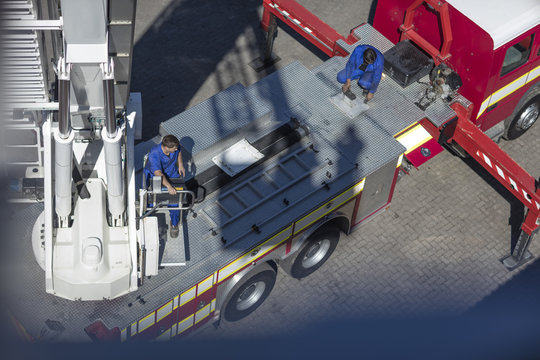 Mechanics maintaining fire engine