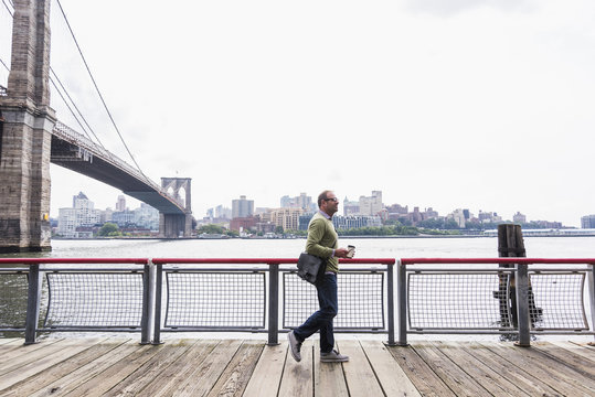 USA, New York City, man walking at East River
