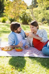 Couple toasting glasses of wine while having breakfast