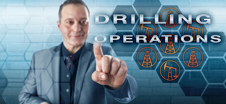 Smiling Industrialist Pushing DRILLING OPERATIONS