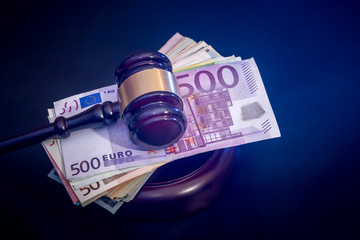 Judges or Auctioneers Gavel Or Hammer with euro money  isolated on black