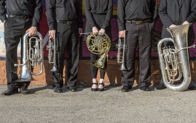 brass instruments lined up on a city street