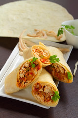 Burritos wraps with chicken and vegetables.