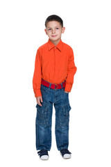 Fototapeta premium Smiling young boy in a red shirt against the white