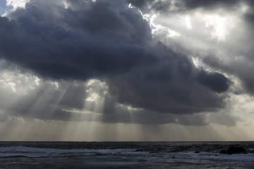 Stormy sea sky with sunbeams