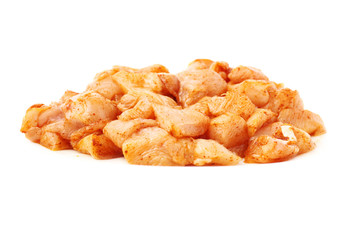 Raw chicken fillet cutted into pieces and spiced isolated over white background