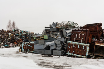 Two big scrap metal heap on snow.