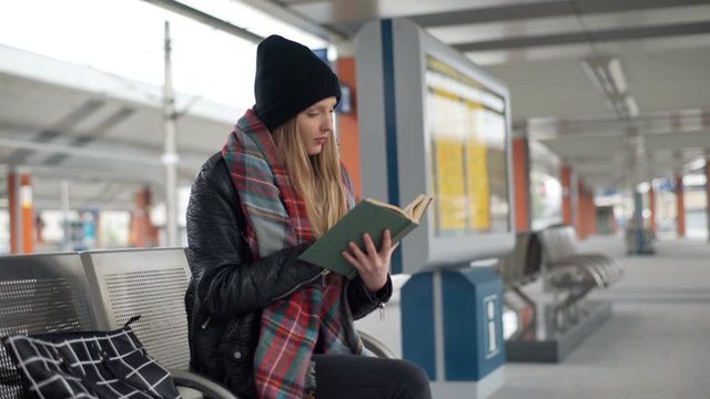 Girl stops reading book because of painful headache
