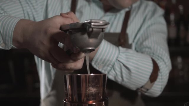 Male Hands Bartender Squeezed Juice Of A Lemon In A Shaker Glass While Making Cocktail