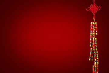 Chinese New Year decoration: Decorative Chinese firecrackers, isolated on red background, vignette, copy space