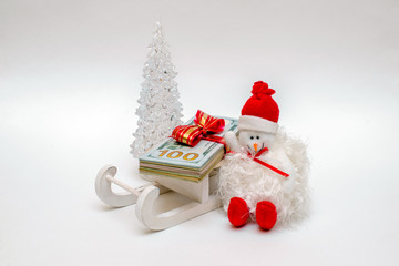 snowman on a sled driven by a stack of American Currency 