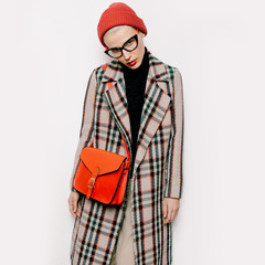 Hipster study time. Pretty Girl in stylish vintage coat and fash