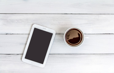   Student or business accessories flatlay.  View from above..Working space on the white wood background with smartphone ,coffee cup,glasses, Notebook