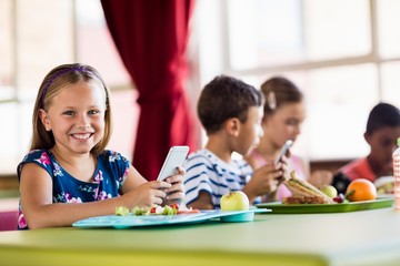 Fototapeta premium Children using technology during lunch