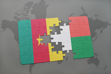 puzzle with the national flag of cameroon and madagascar on a world map.