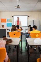 Teacher giving lesson to her students