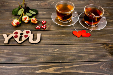 Two transparent cups of black tea standing on wooden surface