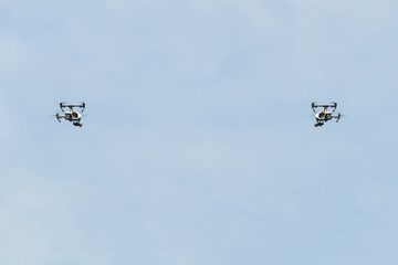 Drone / White drone on blue sky background. Teamwork.