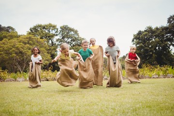Children having a sack race - Powered by Adobe