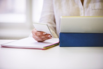 Midsection of executive with technologies 