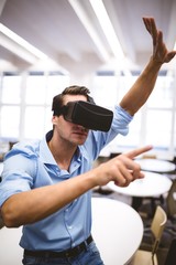 Executive enjoying virtual reality headset at office