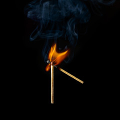 one match ignites another on a black background