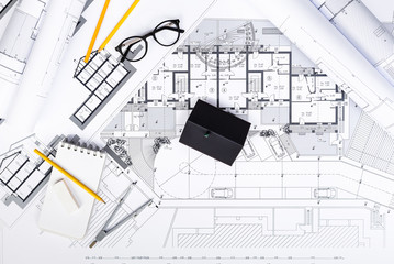 Construction plans with drawing Tools and House Miniature on blu