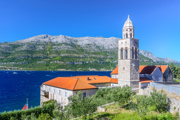 Dominican monastery Korcula island. / View at mediterranean landscape with Dominican Monastery in town Korcula with surfing place Viganj in background, Croatia summertime, Europe. - 128766187