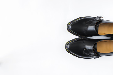 fashion female black shiny leather shoes white background