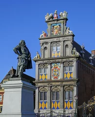 Fotobehang Two sights of the  Hoorn city - Westfries Museum and the Monument of Jan Pieterszoon Coen - on Rode Steen square, The Netherlands © ptashkan