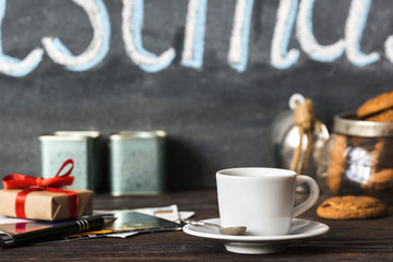 coffee break in the cafe with a little white cup of espresso and cookies, writing postcards