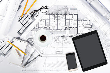Construction plans with Tablet, smartphone and drawing Tools on
