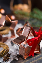 Christmas cookies - copper star-shaped cookies cutters on white