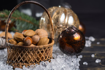 Fototapeta premium Winter Christmas nuts is wicked basket on white ice