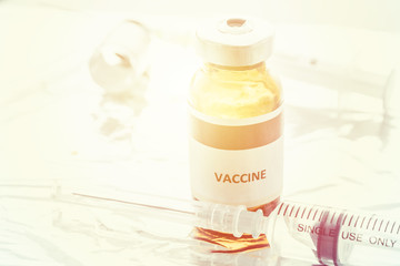Glass Medicine Vials with syringe on white table