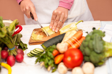 Woman cutting bell pepper on slices