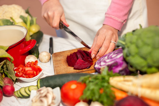 Woman slicing and preparing beetroot