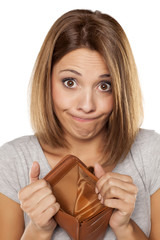 funny woman shows her empty wallet