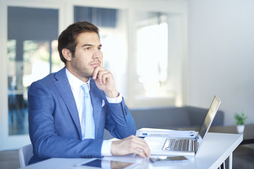 Thoughtful businessman. Confident professional man working in the office