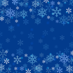 Winter border with white and blue snowflakes on blue blurred soft background. Christmas and New Year holiday wallpaper
