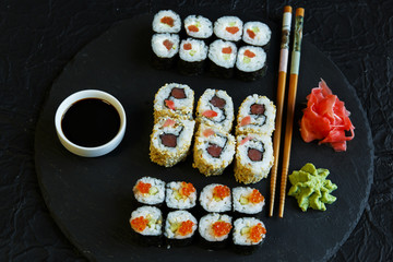  sushi rolls served on stone slate red caviar