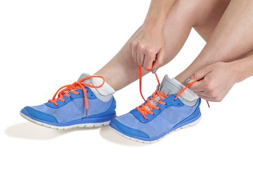 Athlete woman tying her running shoes