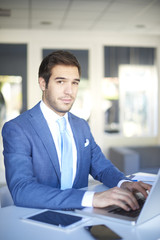 Confident professional businessman working in the office