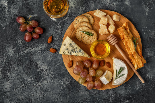 Assortment of cheese with wine, honey, nuts and grape