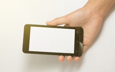hand holding black smart phone isolated, warm tone