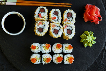  sushi rolls served on stone slate red caviar