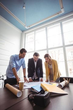 Business People Looking At Blueprint