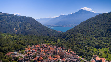 Fototapeta na wymiar Old Italian village. Stone and tale roofs, mountains.
