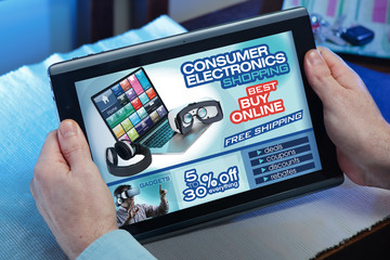 hands in tablet at a website with an announcement concept purchase consumer electronics in web / man searching website on the internet store to purchase consumer technology online at home